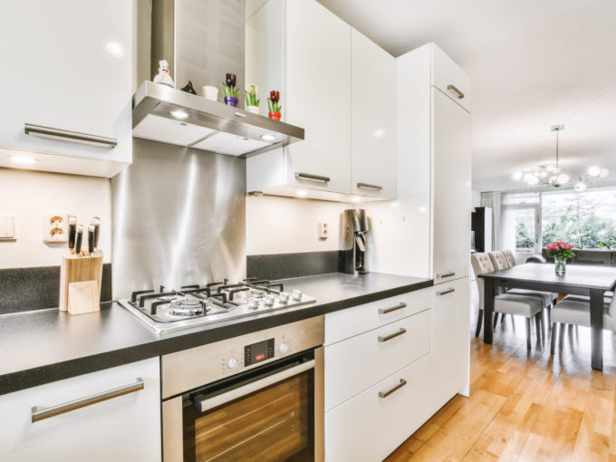 Stylish kitchen with a black countertop Stylish kitchen with a black countertop and a white kitchen set